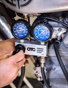 OTC 5609 dual gauges close-up showing clear psi and kPa readings for accuracy