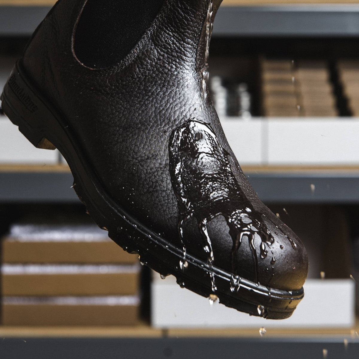 Outdoor boots treated with Otter Wax shedding water for long-lasting protection