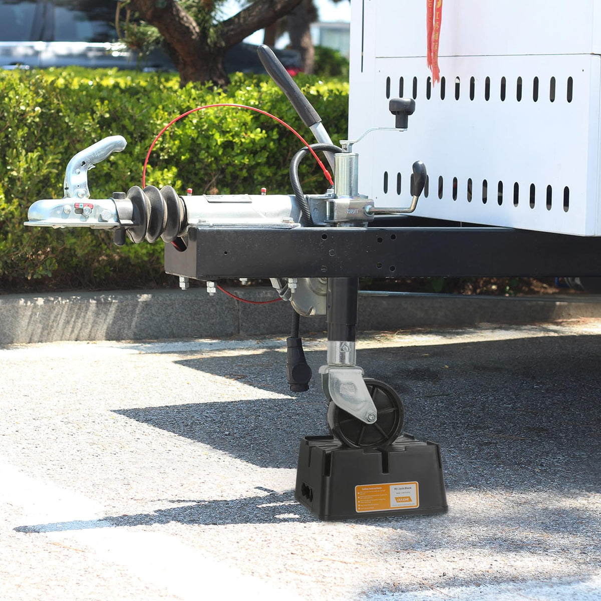 OULEME blocks under travel trailer at campsite showing reliable leveling benefit