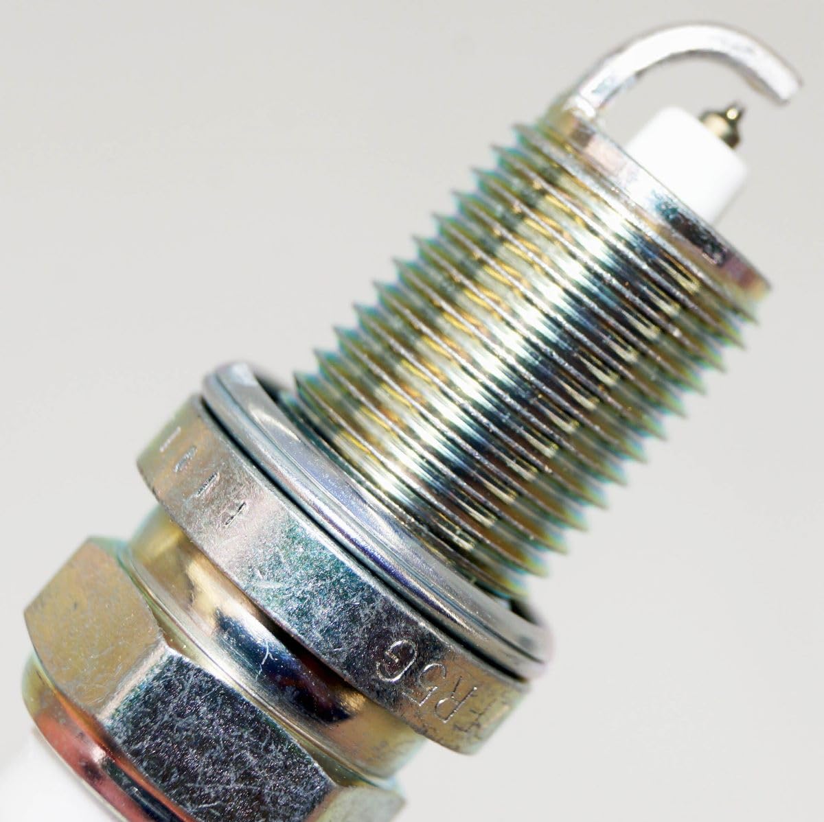 OVERSTOCKDIRECT spark plug installed in marine engine showing reliable fitment