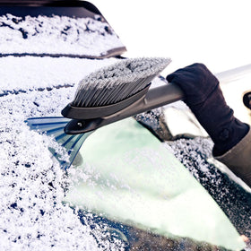OXO brush in use clearing a windshield fast, demonstrating efficient snow removal