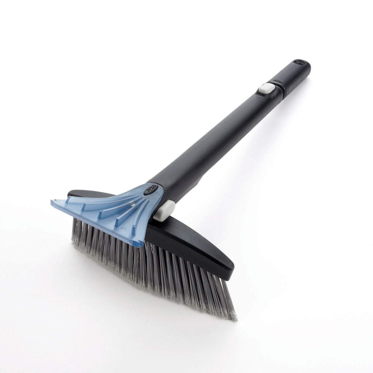OXO brush beside a winter glove to show scale and convenient storage size