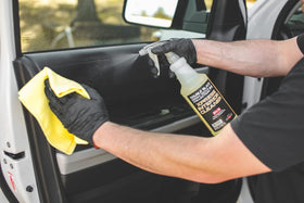 P & S Xpress Interior Cleaner 16 oz bottle next to hand for scale and convenience