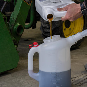 PAK jug in workshop setting being poured into engine fill point illustrating precise transfer