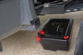 PAK drain pan in garage setting capturing oil under vehicle for cleaner maintenance