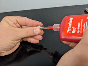 Permatex 27140 red threadlocker close-up highlighting adhesive texture and consistency