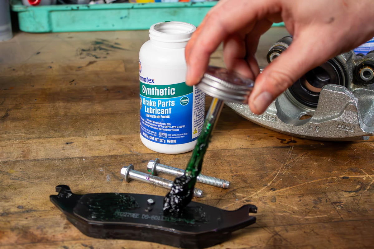 Permatex applied on caliper pin during service to prevent sticking and ensure smooth movement