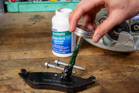 Permatex applied on caliper pin during service to prevent sticking and ensure smooth movement