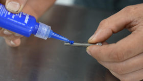 Permatex blue gel texture on fingertip demonstrating non-drip control