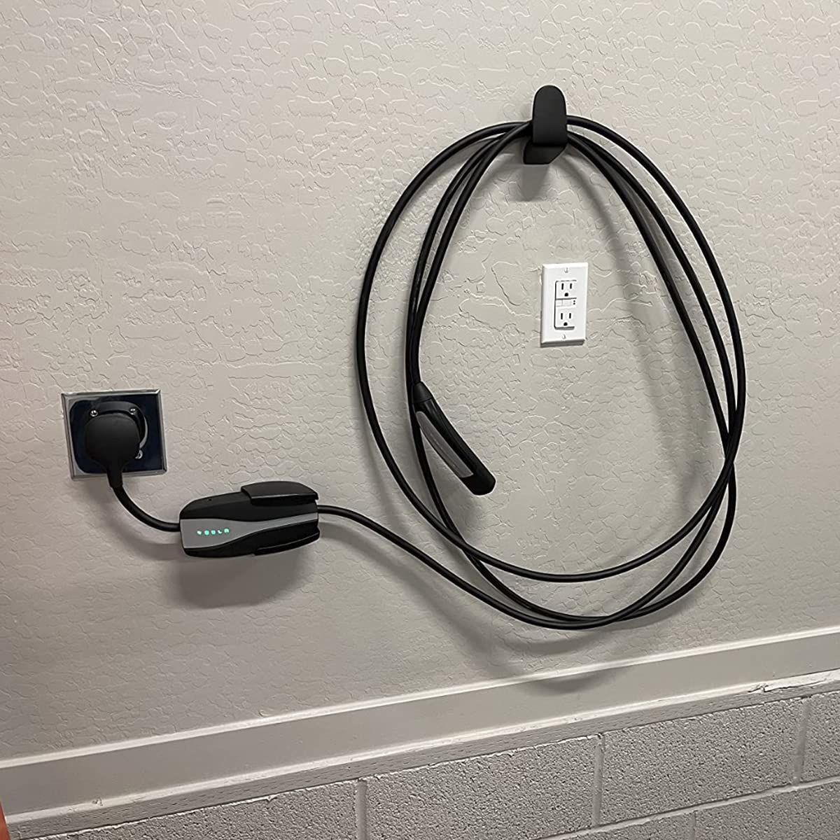 PHEOKER mounted near wall outlet showing proper placement and protected adapter