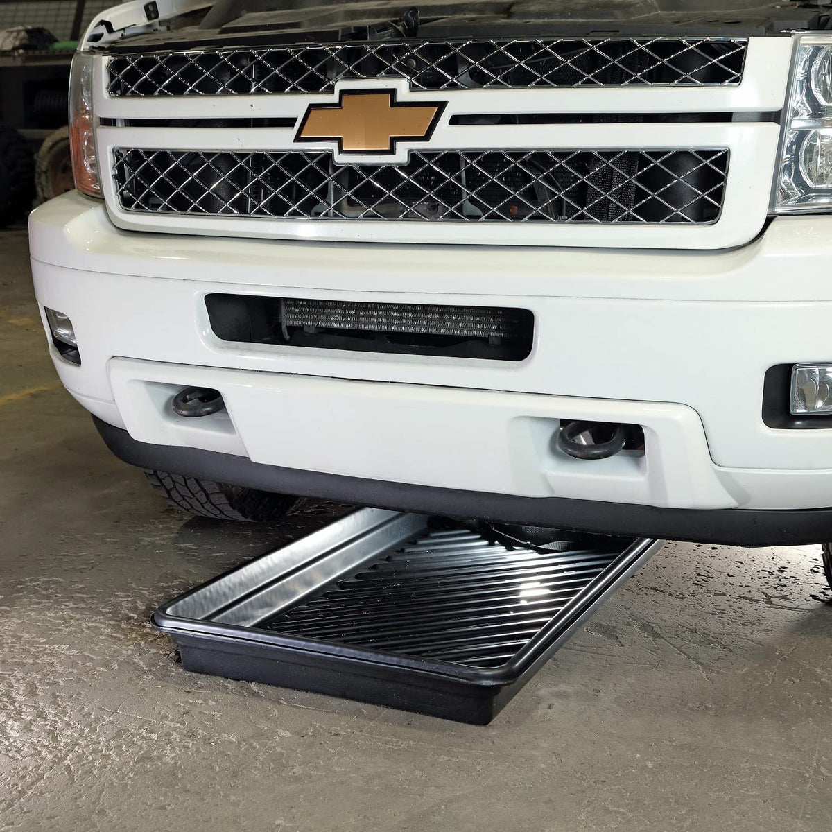 PIG tray holding small leaking containers protecting floor from spills