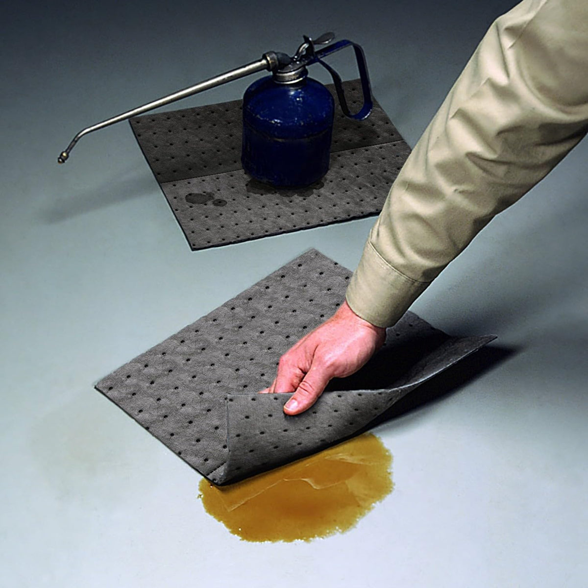 PIG pad being pulled from dispenser box, easy single-hand use