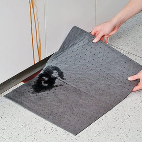 PIG pad on garage workbench catching drips, keeps surfaces clean