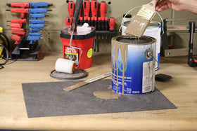 PIG mat roll laid under a car in a garage offering spill protection and easy cleanup