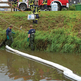 PIG oil boom deployed from boat confining oil on water for fast spill control