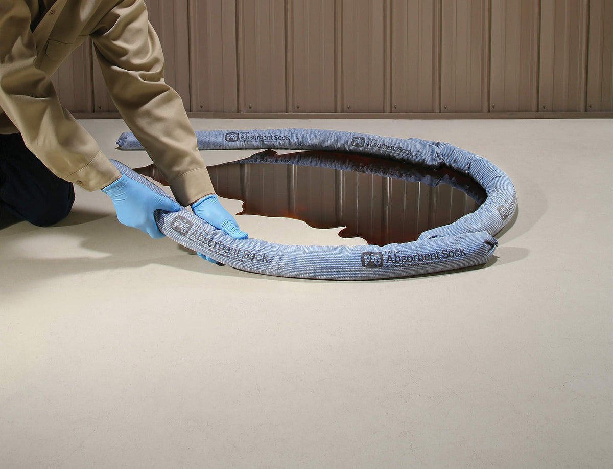 PIG socks deployed diking a spill on a factory floor to prevent spread
