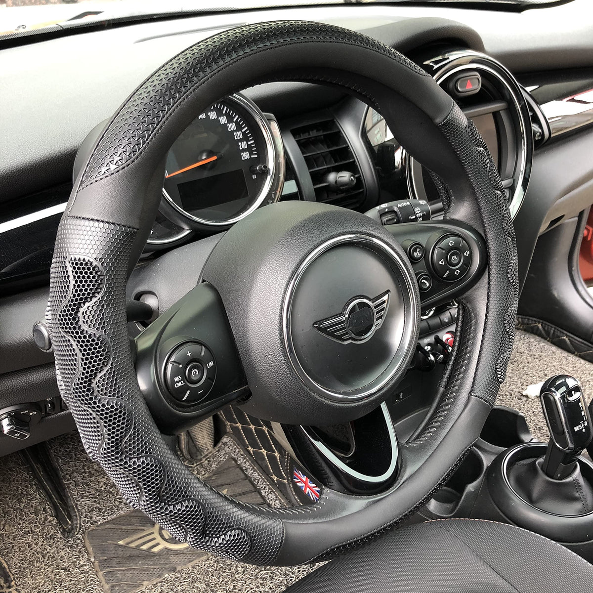 PINCTROT front view of all-black steering wheel cover showing sleek fit and style
