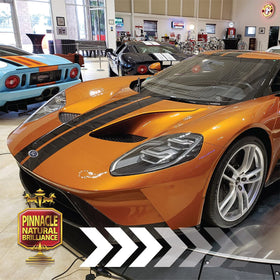 Pinnacle Natural Brilliance finished car in a showroom setting demonstrating mirror-like shine and depth