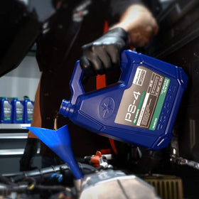 Polaris PS-4 bottle next to an ATV showing correct volume and size comparison