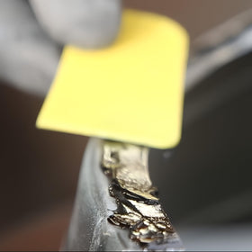 Polymix adhesive bead close-up on metal seam, shows smooth joint formation and adhesion