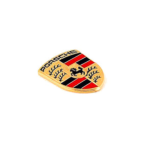 Porsche crest next to coin showing compact size and correct proportions for keys