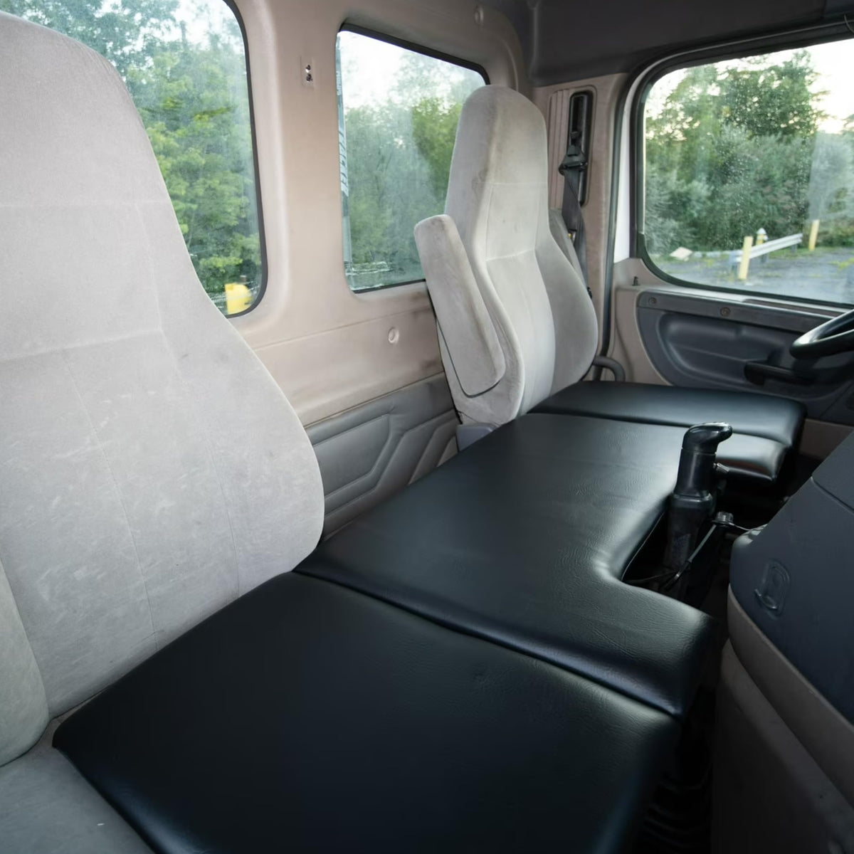 Presto Day Bed unfolded across truck seats offering stable resting surface