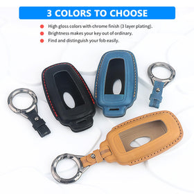 QBUC black key fob sitting on car dashboard showing refined in-car style