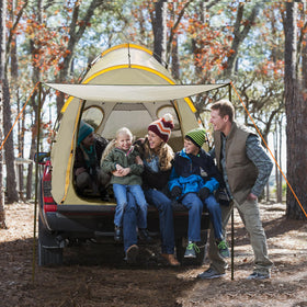 Qualencey with people next to tent demonstrating scale and sleeping capacity