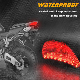 QUASCO smoked tail light next to ruler showing compact size and fitment