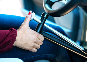 QuicStick folded portable beside seat illustrating compact transportability