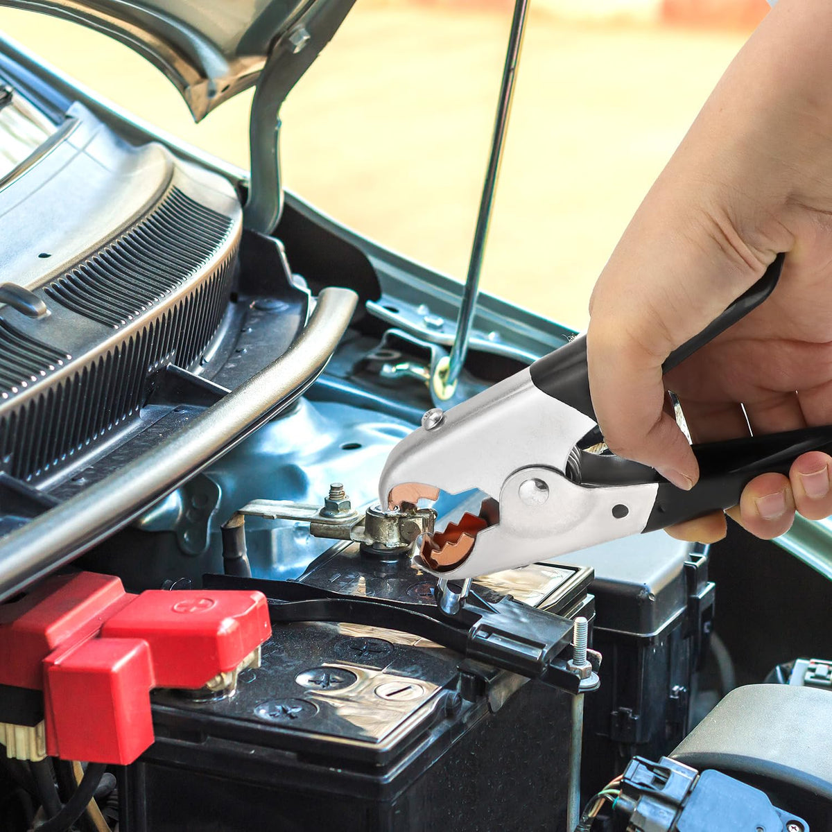 QWORK clamps attached to a boat battery highlighting corrosion resistance and marine use
