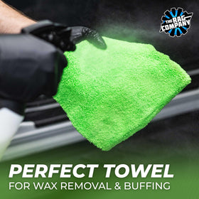 Hand holding a 16x16 Rag Company towel showing size and easy control for detailing