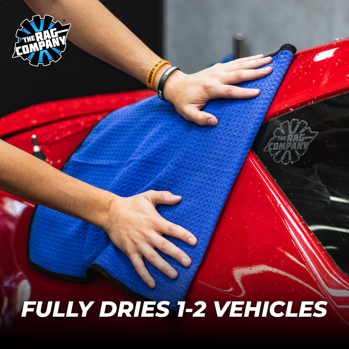 The Rag Company towel in hand soaking water to demonstrate superior absorbency benefit