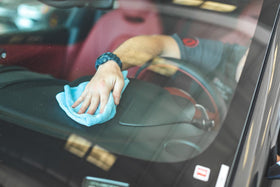 The Rag Company towel held in hand to show 16x16 size and easy handling
