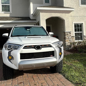 RAVOTOM lifestyle shot on road showcasing durable trim and enhanced front styling