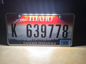 Red Flag Robotics mounted on license plate showing compact size and correct illumination