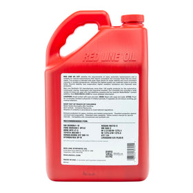 Red Line bottle beside measuring cup showing gallon scale and precise dosing