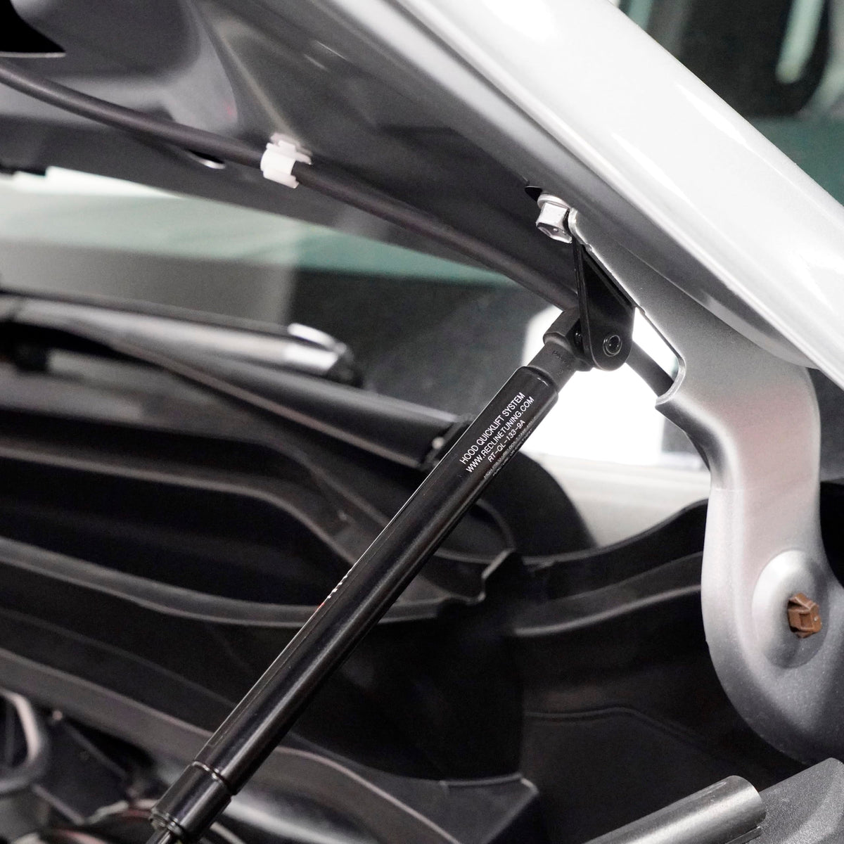 Redline Tuning installed on Tacoma with open hood demonstrating one-handed lift convenience