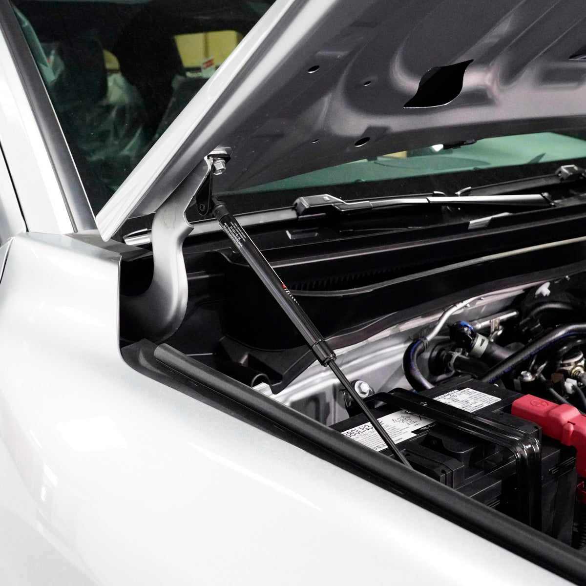 Redline Tuning lifestyle garage scene showing QuickLIFT aiding maintenance and convenience
