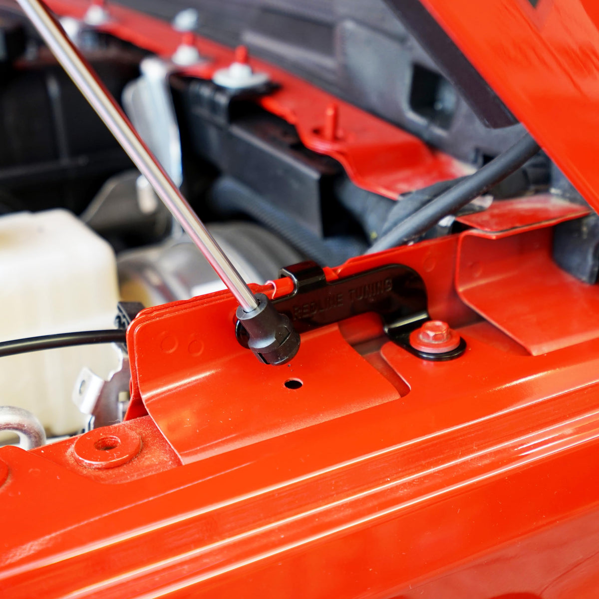Redline Tuning mounting bracket detail showing bolt-in hardware and fitment