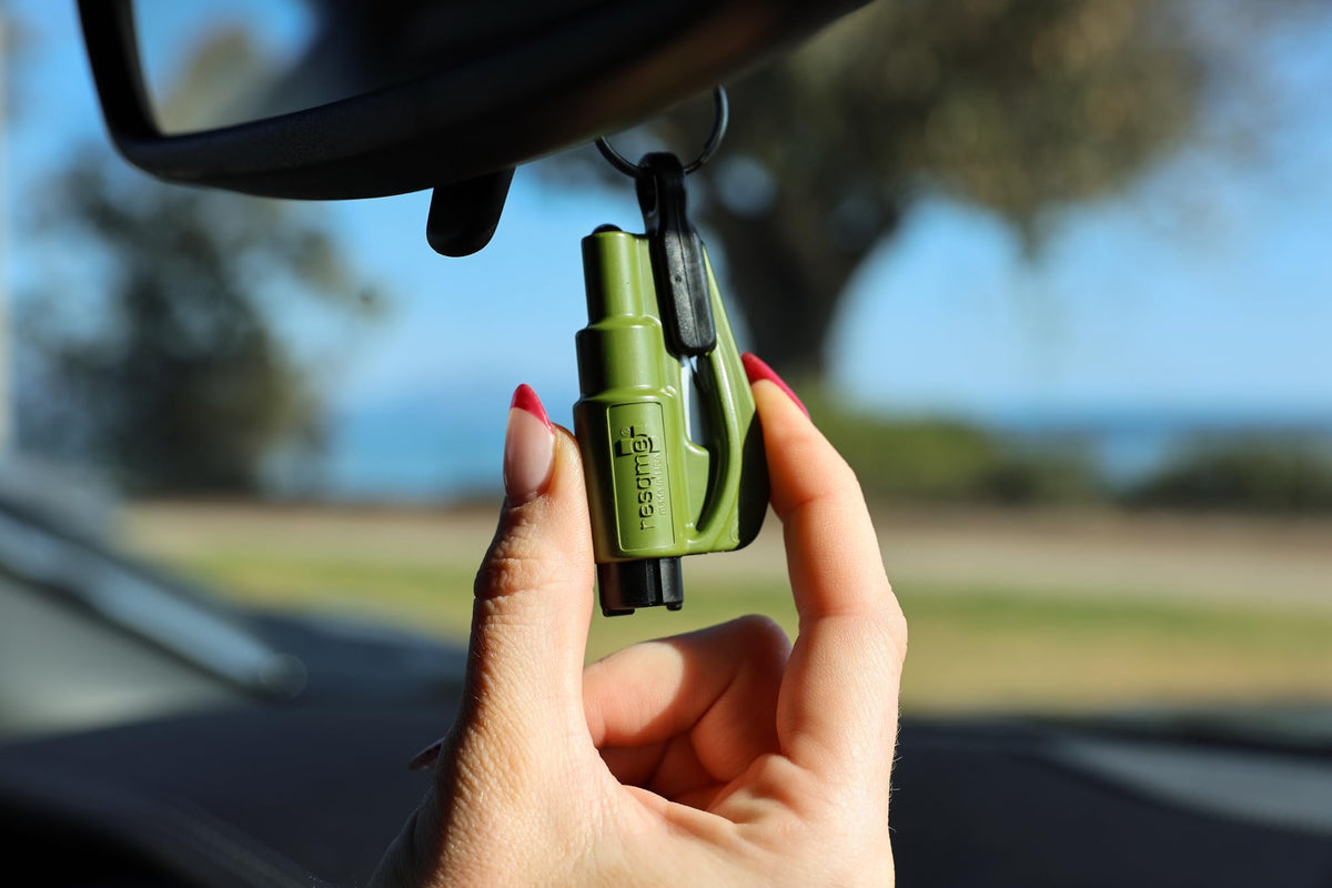 RESQME clipped to a sun visor inside a car for immediate reach in emergencies