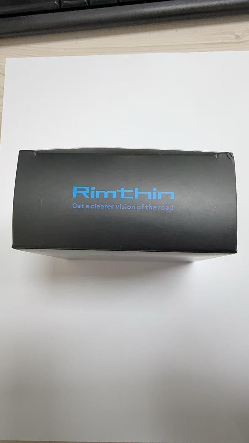 rimthin beside coin for scale showing compact size and fit