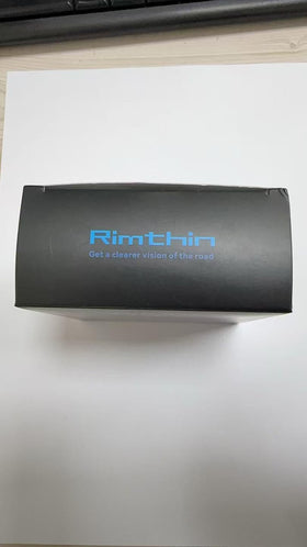 rimthin beside coin for scale showing compact size and fit