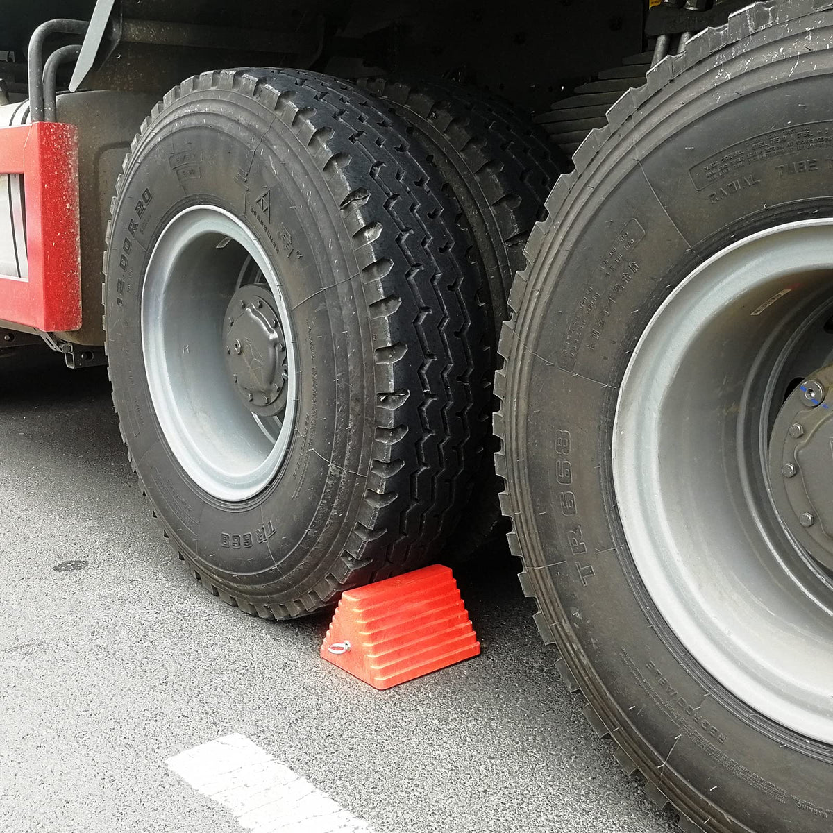 ROBLOK chock held in hand for scale showing lightweight portability benefit