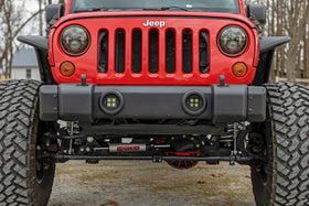 Rough Country lifestyle shot of Wrangler with caps climbing trail showing functional benefit