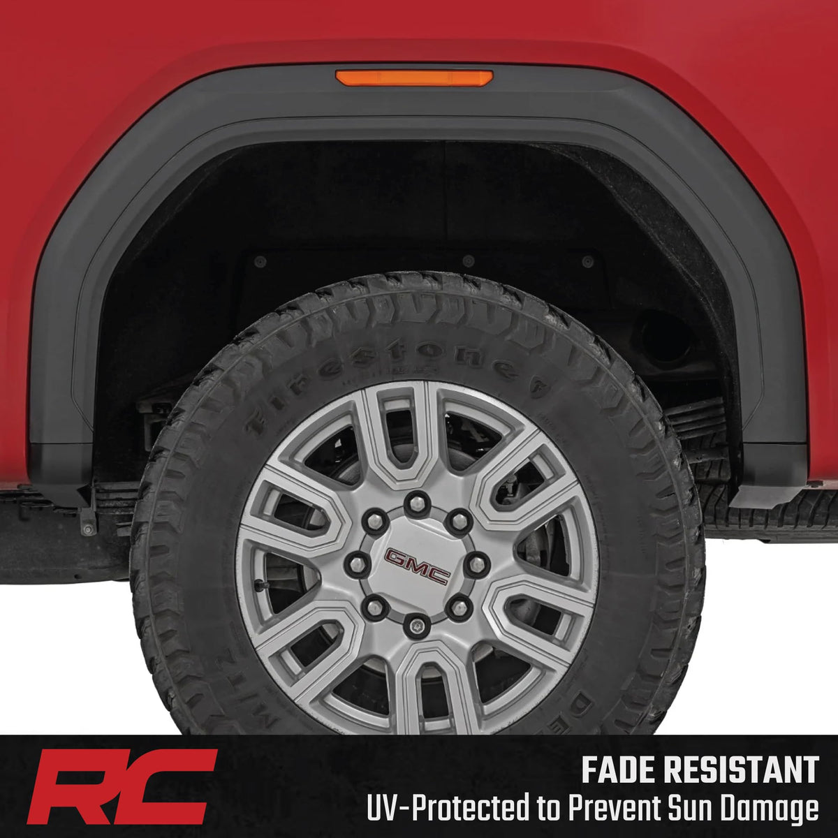 Rough Country-equipped Sierra driving on road showing refined appearance