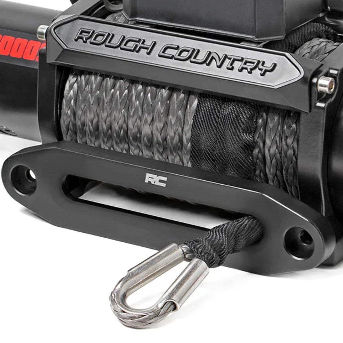 Rough Country winch beside hand showing size and weight for practical vehicle fitment