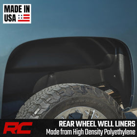 Rough Country rear liners on truck splashing mud showcasing debris protection benefit