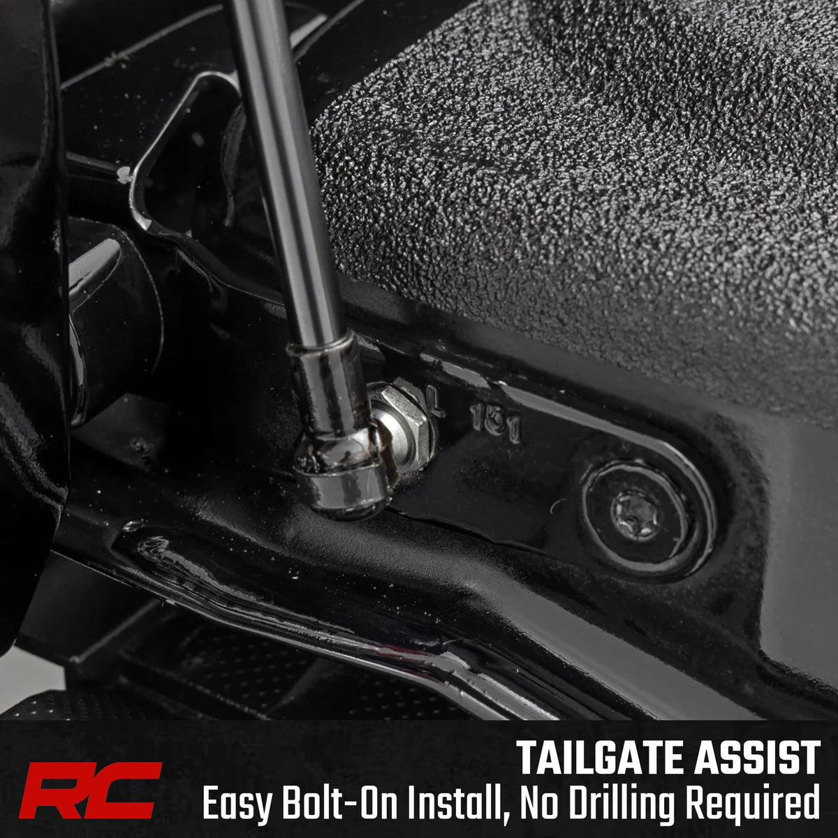 Rough Country tailgate assist beside ruler showing compact size and fitment benefit