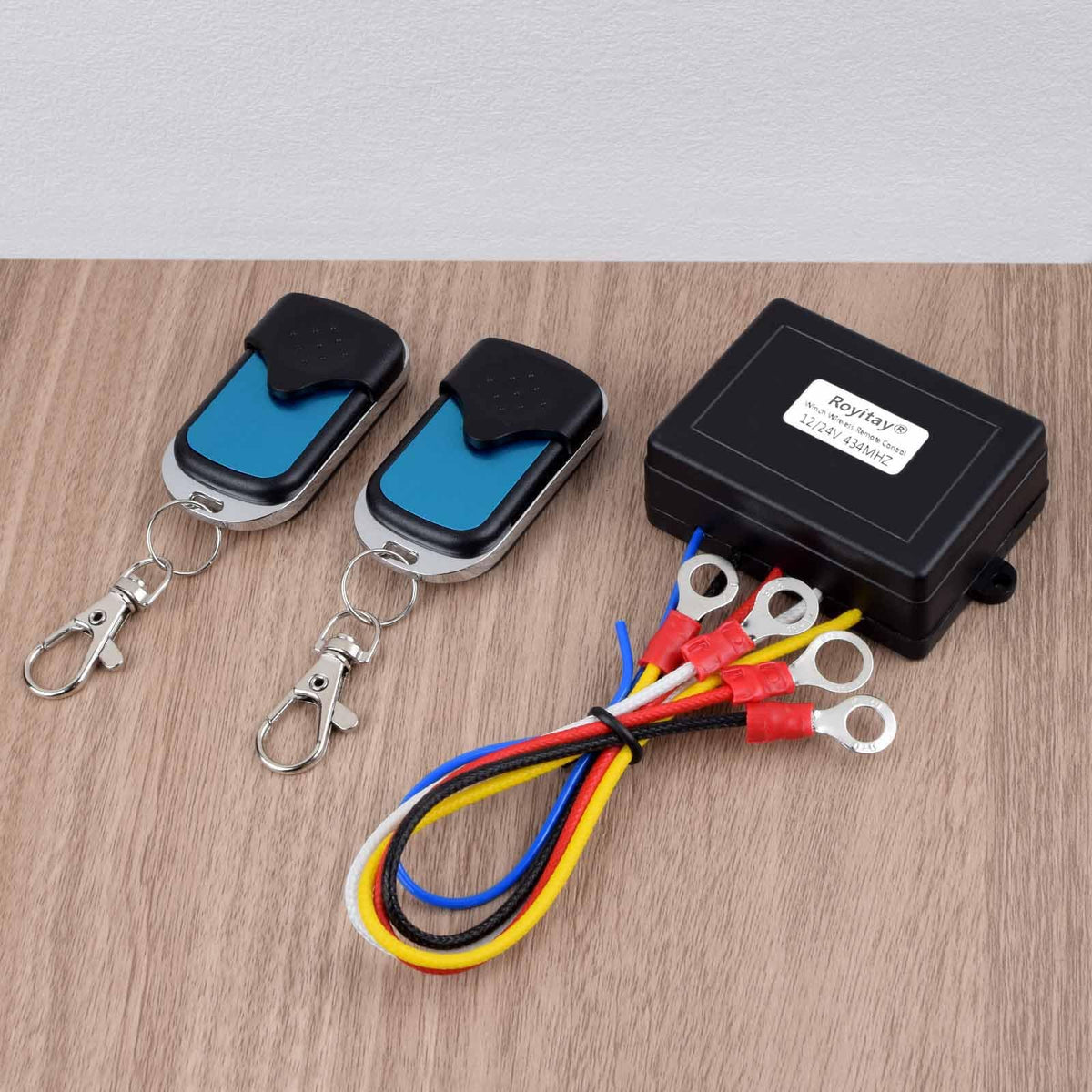 Royitay remote held in hand to show size and ergonomic handling benefit